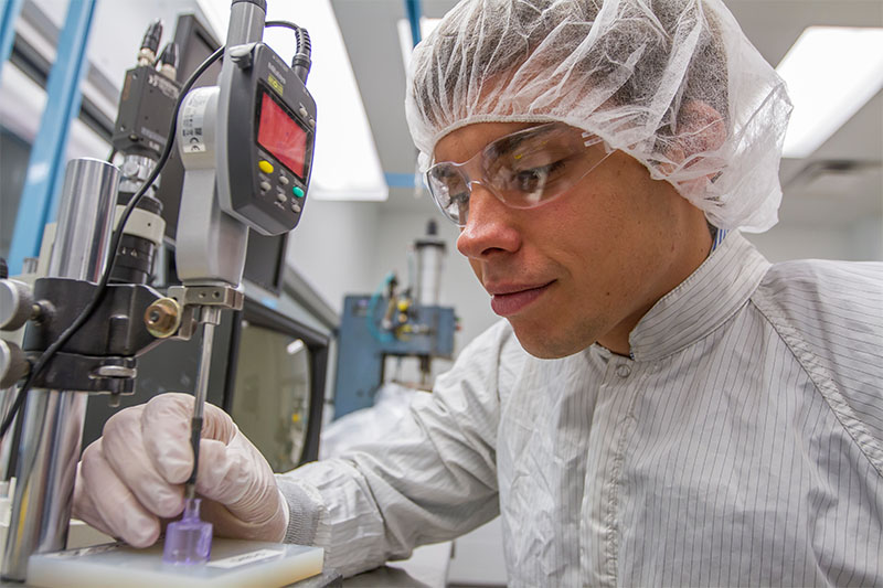 close up of a man wearing clean room gear