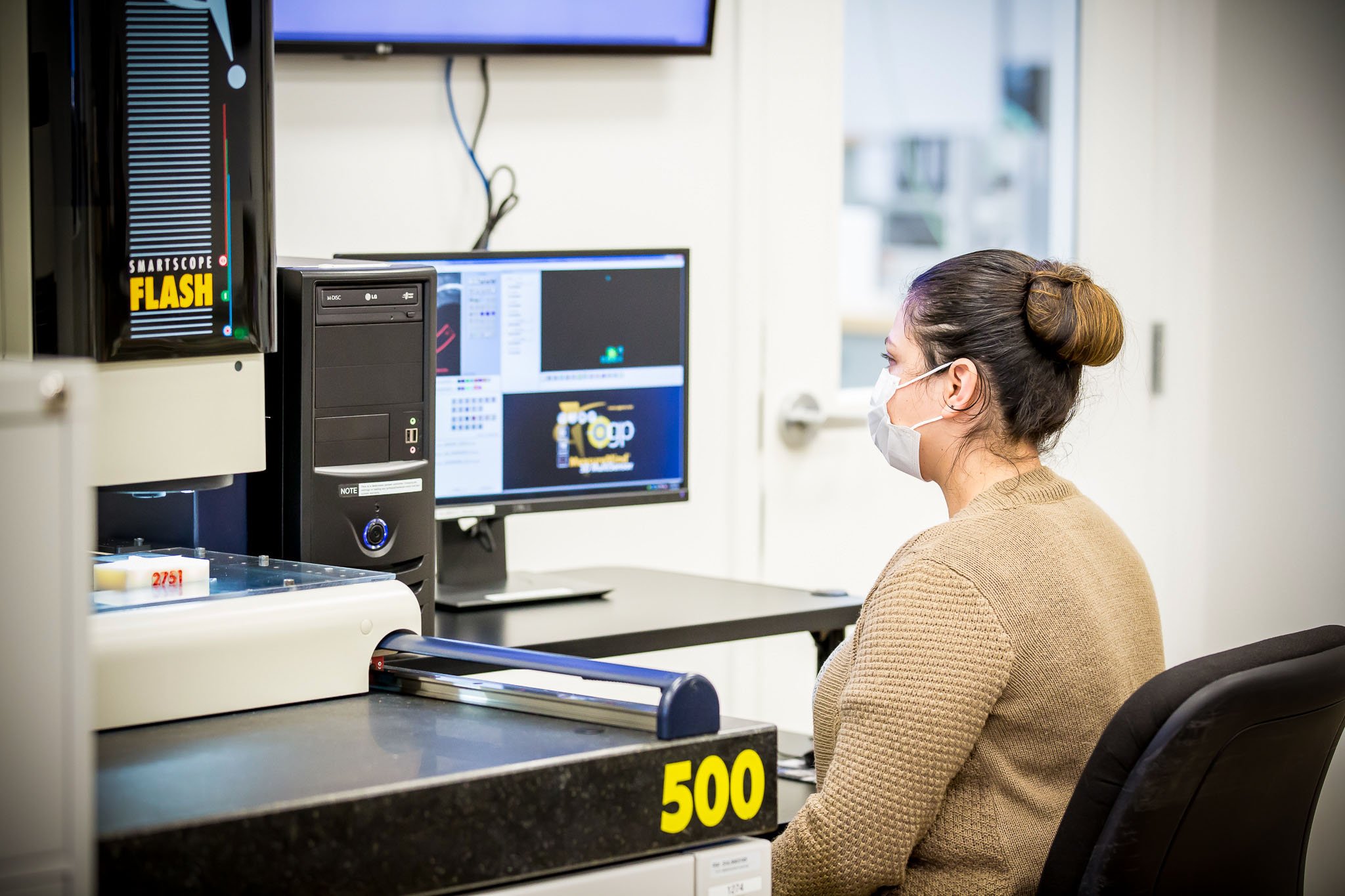 Woman working machine in front of computer